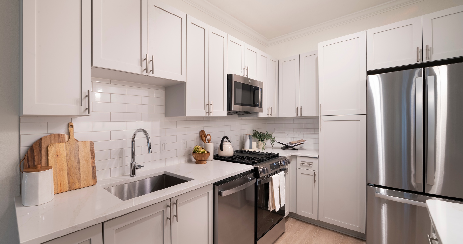 Kitchen with white stone counters and cabinets